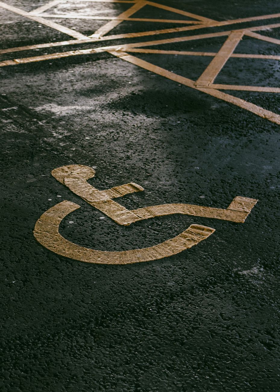 disability icon painted on asphalt pavement