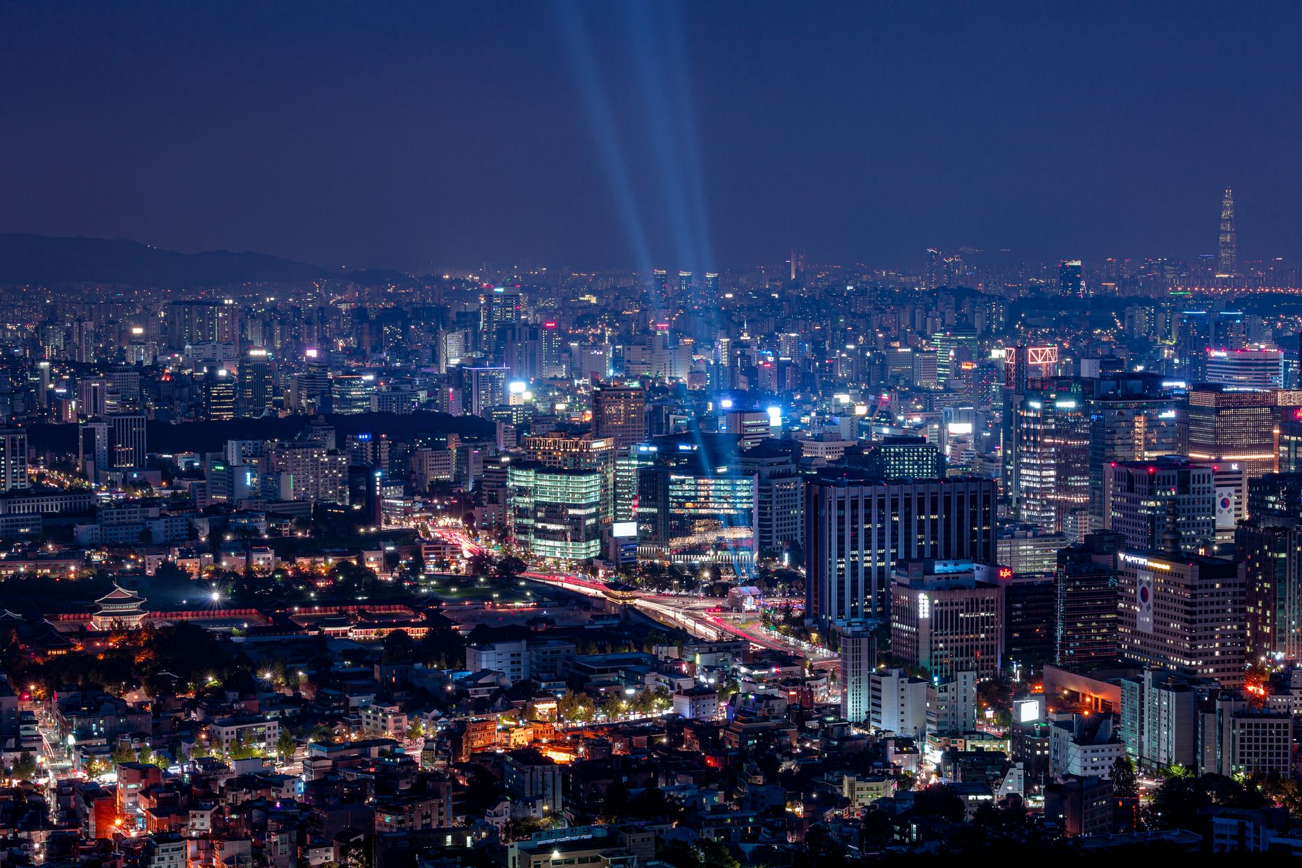 light display over illuminated city at night